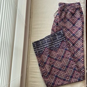 Wide leg patterned pants with front pockets and drawstring waist.